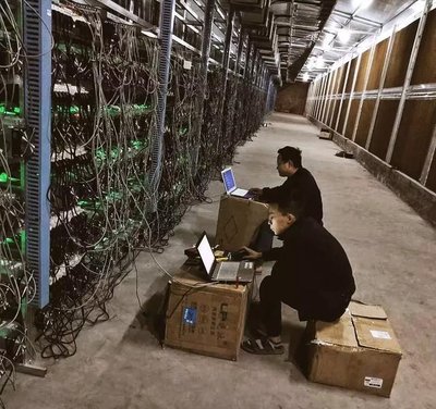 A modern mining farm with rows of mining machines